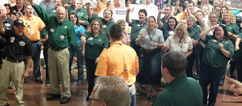 Jarron Richie, center, store manager for Bass Pro Shops in East Ridge, leads a cheer with his employees prior to the opening late Wednesday. 
