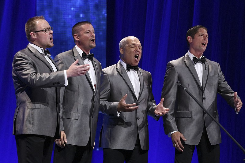 
              This July 9, 2016 image released by Barbershop Harmony Society shows, members of the barbershop quartet Forefront, from left, Drew Wheaton, Kevin Hughes, Brian O'Dell and Aaron Hughes, during a competition at the Bridgestone Arena in Nashville, Tenn. The group took home the Barbershop World Quartet gold medal. ( Lorin May/Barbershop Harmony Society via AP)
            