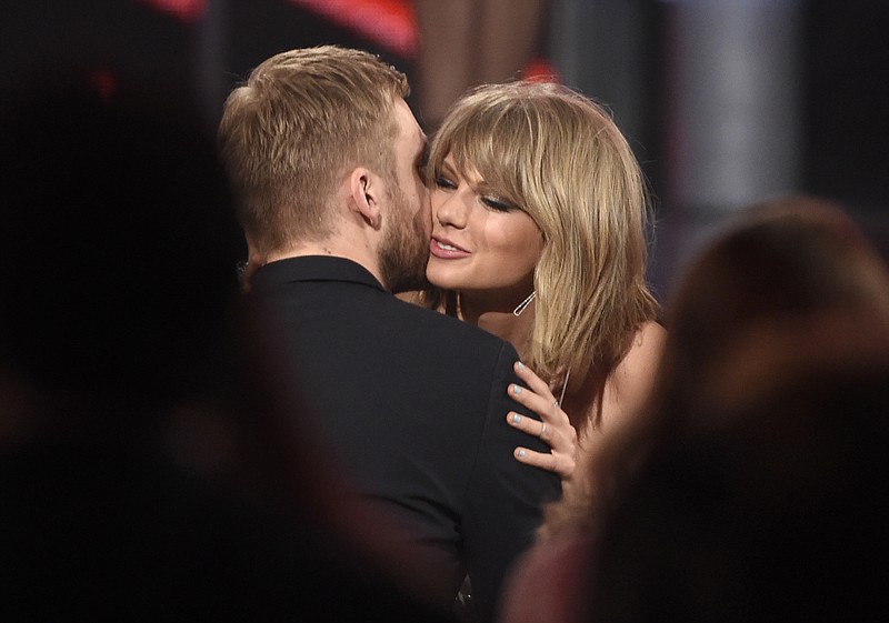 
              FILE - In this May 17, 2015 file photo, Taylor Swift, right, hugs Calvin Harris after winning the award for top billboard 200 album for "1989" at the Billboard Music Awards at the MGM Grand Garden Arena  in Las Vegas. Swift has confirmed that she co-wrote ex-boyfriend’s Calvin Harris’ latest hit song under an alias, which prompted the DJ-producer to send a series of angry tweets Wednesday, July 13, 2016. (Photo by Chris Pizzello/Invision/AP)
            