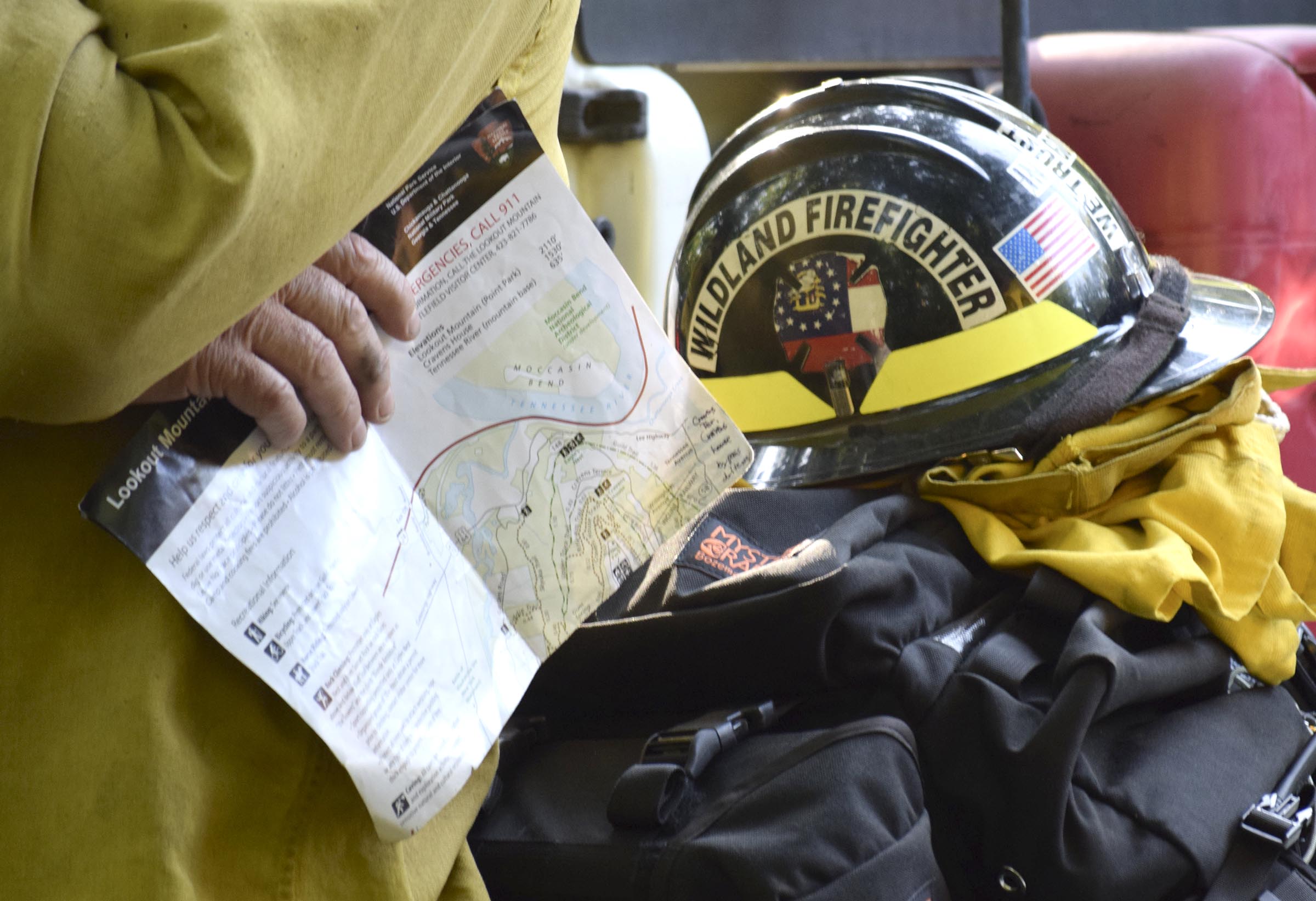 A Georgia Forestry Commission Ranger holds a map of Lookout Mountain while his equipment is piled behind him.  Multiple agencies united to fight a wildfire on the west slope of Lookout Mountain below Covenant College Thursday July 14, 2016.