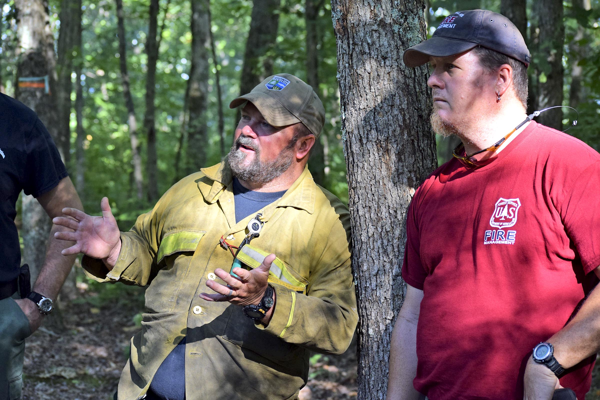From left, Georgia Forestry Commission Chief Ranger for Dade County, Heath Morgan, discusses the mountain terrian as United States Forest Service Fire Management Officer for the Conasaga District, Jeff Sharp looks on.  Morgan and Sharp co-directed the effort until the National Park Service took over at 1:00 p.m. Thursday.  Multiple agencies united to fight a wildfire on the west slope of Lookout Mountain below Covenant College Thursday July 14, 2016.