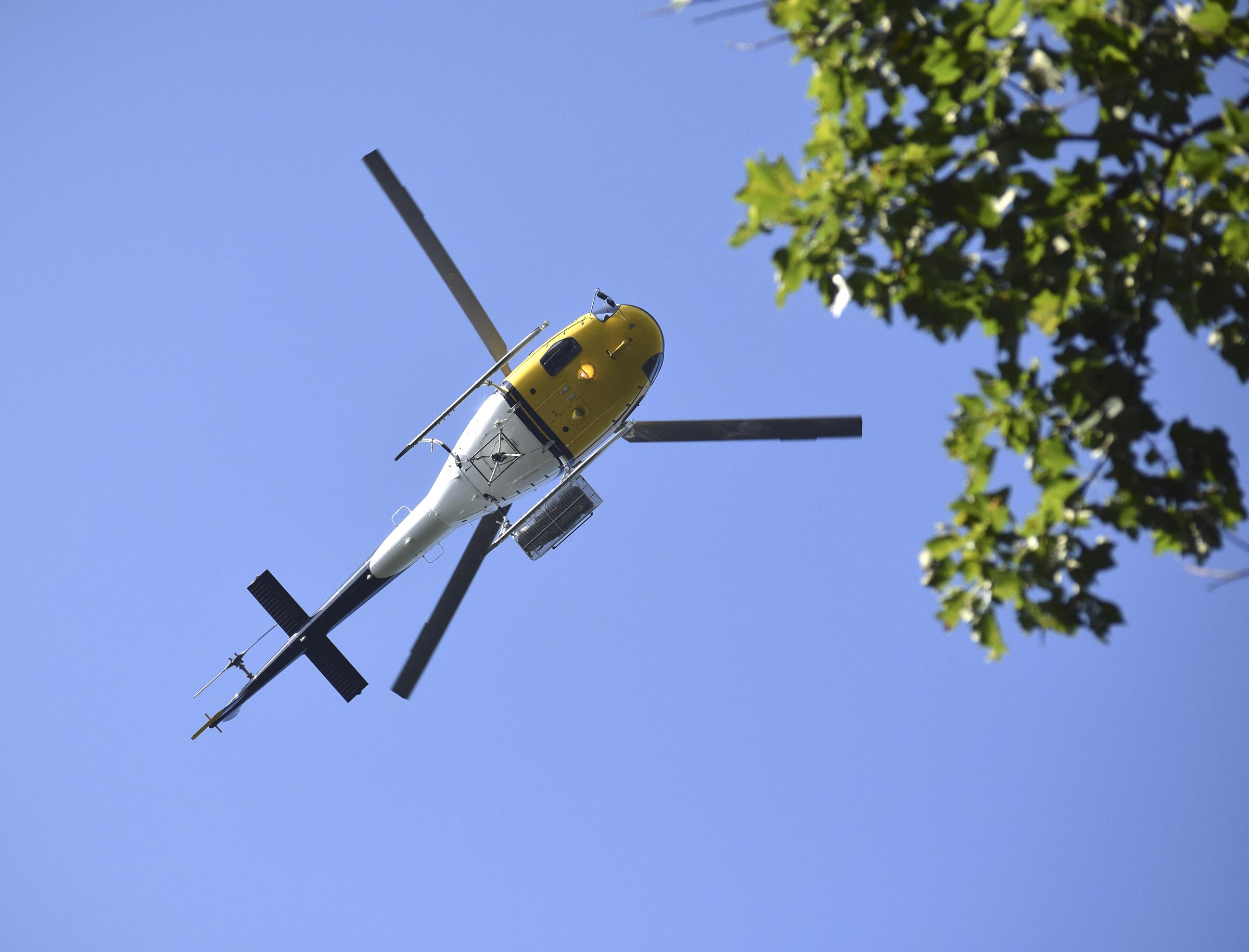 A helicopter circles the staging area to aid in containing a wildfire.  Multiple agencies united to fight a wildfire on the west slope of Lookout Mountain below Covenant College Thursday July 14, 2016.