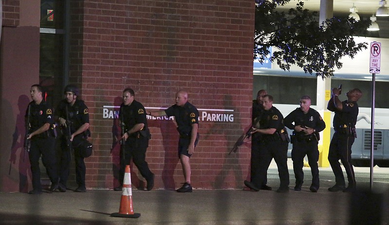 
              FILE - In this Thursday, July 7, 2016 file photo, Dallas police respond after shots were fired during a protest over recent fatal shootings by police in Louisiana and Minnesota, in Dallas. Police in Dallas were the first in the nation to use a robot to deliver and detonate a bomb to kill a suspect, but other law enforcement agencies are willing and able to follow suit, including some that even have trained for the day when they’d have to do so. The killing of Micah Johnson using a robot-delivered bomb ended a night of terror in which he shot 14 officers, killing five of them, and also wounded two civilians. (Maria R. Olivas/The Dallas Morning News via AP, File)
            