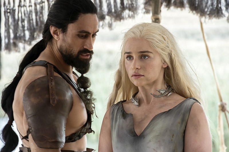 
              This image released by HBO shows Joe Naufahu, left, and Emilia Clarke in a scene from the season six premiere of "Game of Thrones." On Thursday, July 14, 2016, Clarke was nominated for outstanding supporting actress in a drama series for her role. The 68th Primetime Emmy Awards will be broadcast live on ABC beginning at 8 p.m. ET on ABC. (Macall B. Polay/HBO via AP)
            