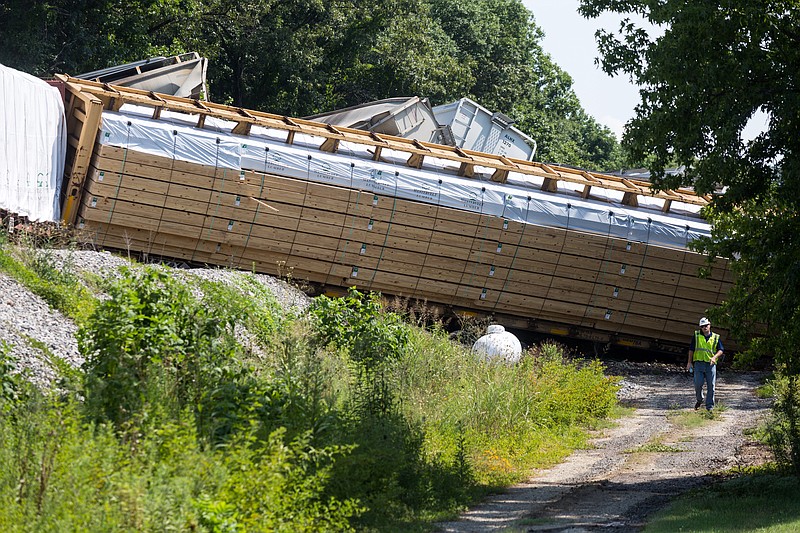 A worker walks near a train derailment after a train hit a semi-trailer on Wauhatchie Pike in Lookout Valley on Thursday.