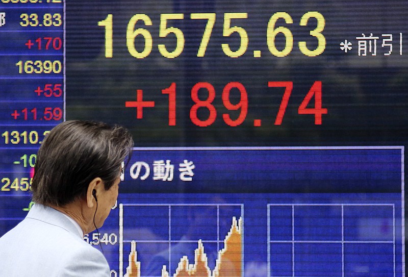 
              A man looks at an electronic stock board of a securities firm in Tokyo, Friday, July 15, 2016. Asian shares were higher Friday after China reported steady economic growth in the second quarter of the year. Stocks also tracked a bullish session overnight on Wall Street, as strong earnings reports pushed the Dow Jones industrial average and S&P to fresh record highs. (AP Photo/Koji Sasahara)
            