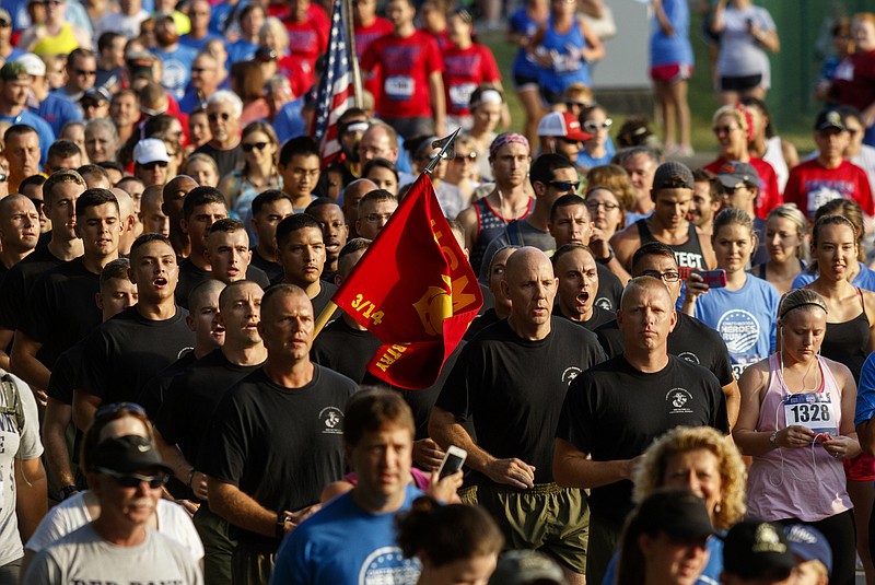 United States Marines from Mike Battery run at the center of a crowd as the inaugural Chattanooga Heroes' Run begins at the Naval Operational Support Center and Marine Corps Reserve Center off of Amnicola Highway.