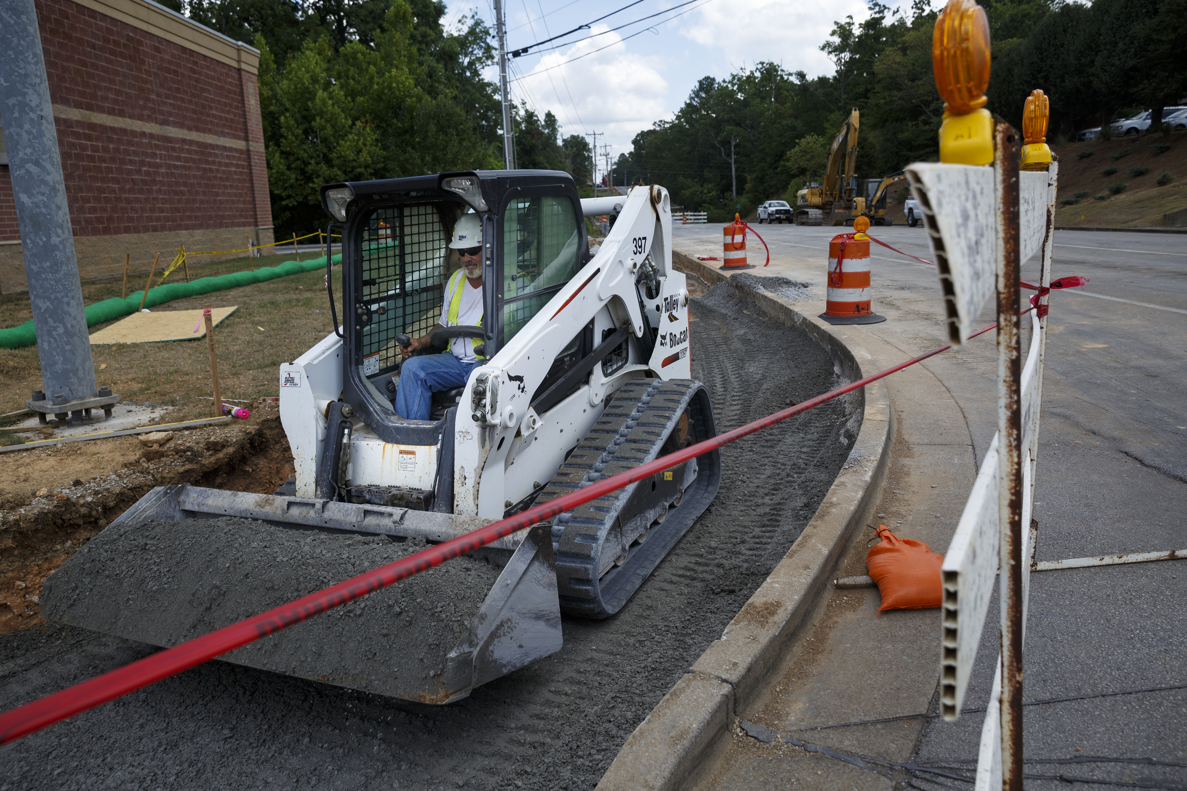 David Boyle operates an excavator on Gunbarrel Road between Shallowford Road and Preston Circle on Friday, July 15, 2016, in Chattanooga, Tenn. The section of road is closed to traffic for a widening project.