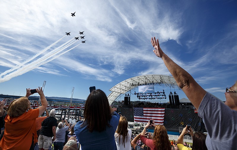 A single jet pulls away from formation to form a missing man formation during a Blue Angels flyby of the Chattanooga Unite Tribute Concert at Ross's Landing on Wednesday, Sept. 16, 2015, in Chattanooga, Tenn. Samuel L. Jackson, a Chattanooga native, emceed the benefit concert for families of victims of the July, 16, shootings at military facilities in Chattanooga.