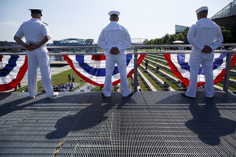 U.S. Navy sailors "man the rail" at a memorial service at Ross's Landing for the 5 servicemen killed in last July's attack on two area military facilities on Saturday, July 16, 2016, in Chattanooga, Tenn. Saturday marked one year since the attack by a lone gunman at a Lee Highway military recruiting center and the Naval Operational Support Center and Marine Corps Reserve Center off of Amnicola Highway.