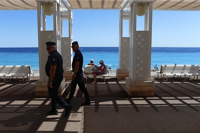 
              Police patrol near the scene of a truck attack on the famed Promenade des Anglais in Nice, southern France, Saturday, July 16, 2016. French Interior Minister Bernard Cazeneuve says that the truck driver who killed 84 people when he careened into a crowd at a fireworks show was "radicalized very quickly." (AP Photo/Francois Mori)
            