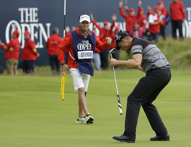 Swedish golfer Henrik Stenson, right, celebrates his win Sunday at the British Open. Looking on is caddie Gareth Lord, who came from England to play college golf at UTC in the early 1990s and is still a member at Chattanooga Golf and Country Club.