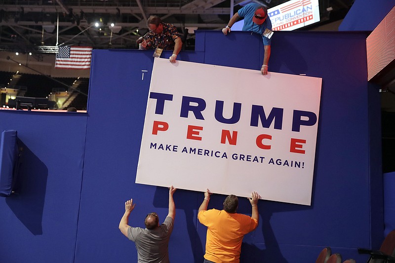 
              Workers place a sign as they prepare at Quicken Loans Arena for the Republican National Convention, Sunday, July 17, 2016, in Cleveland. (AP Photo/Matt Rourke)
            