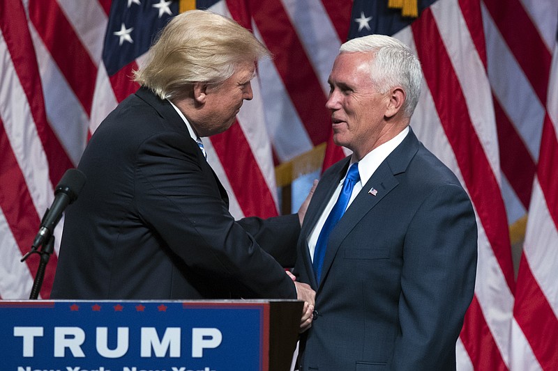 Republican presidential candidate Donald Trump, left, shakes hands with Gov. Mike Pence, R-Ind., during a campaign event to announce Pence as the vice presidential running mate on Saturday.