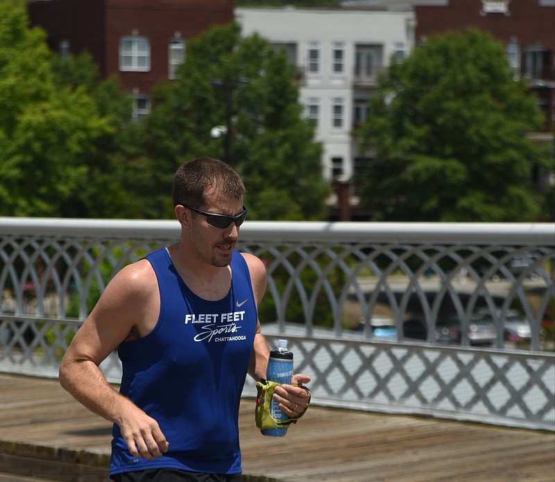 David Pharr runs on July 11 across the Walnut Street Bridge.