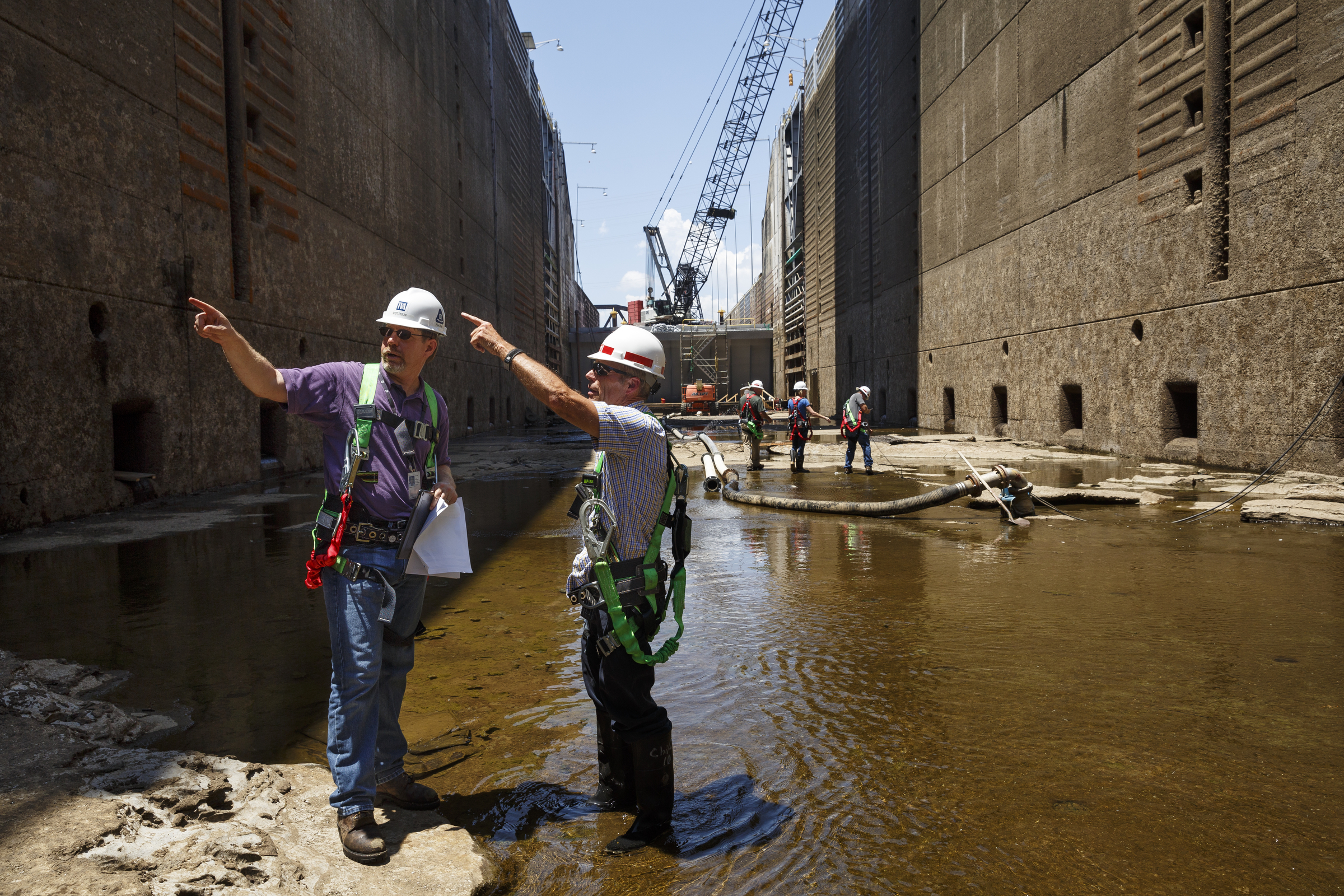Tom Hale, Army Corps of Engineers operations manager for the Tennessee River navigation area, right, talks with Scott Fielder inside the dewatered Chickamauga Lock at the Chickamauga Dam on Wednesday, July 20, 2016, in Chattanooga, Tenn. The lock is being dewatered for routine maintenance checks.