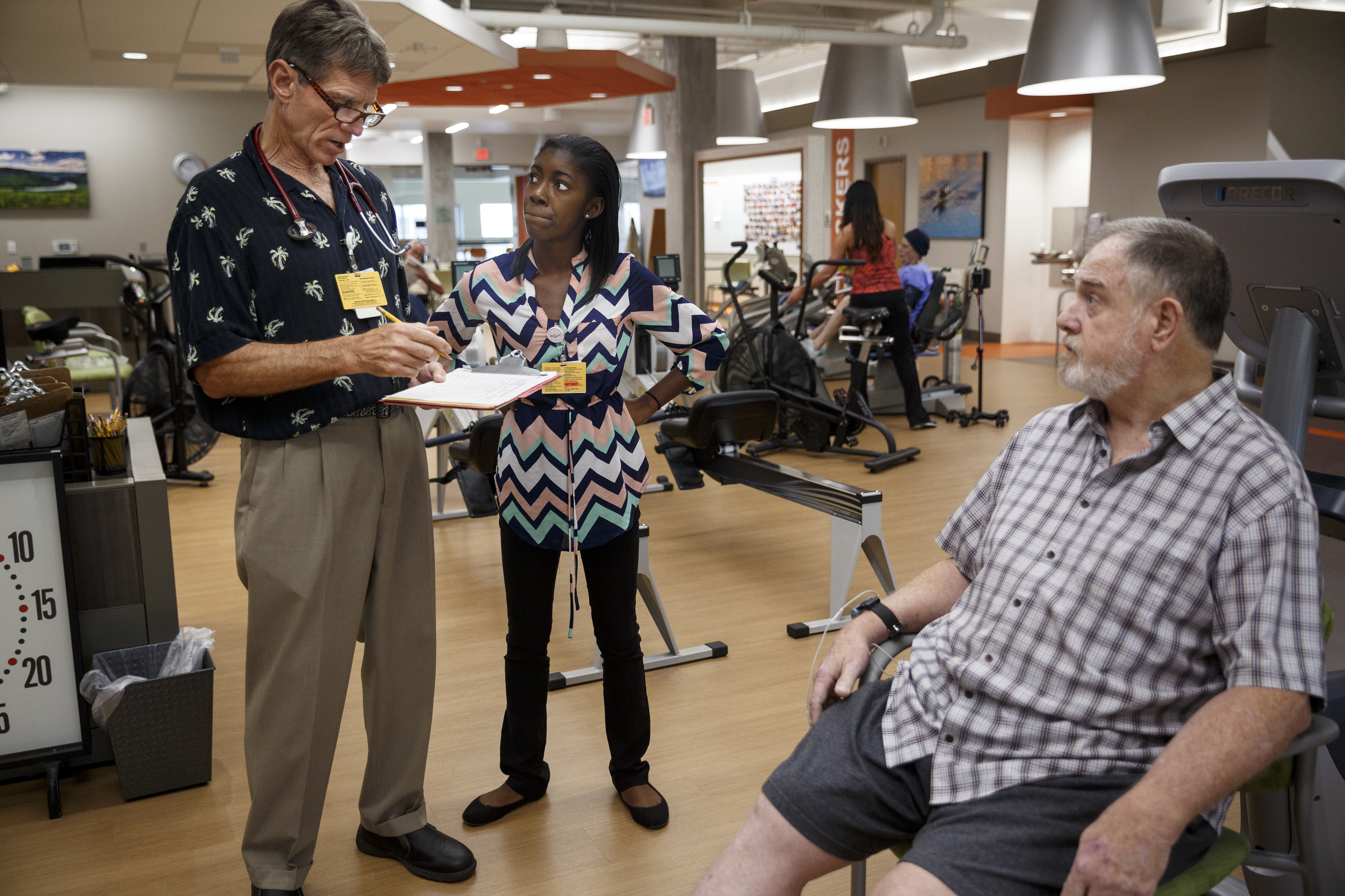 Intern Makalah Smith, center, listens as cardiac rehab manager Allan Lewis, left, explains upcoming exercises to patient Richard Sullivan in CHI Memorial Hospital's cardiac rehabilitation facility on Thursday, July 14, 2016, in Chattanooga, Tenn. More than 40 businesses and organizations in Hamilton County have offered paid internships to high school students through the Step-Up Chattanooga program.