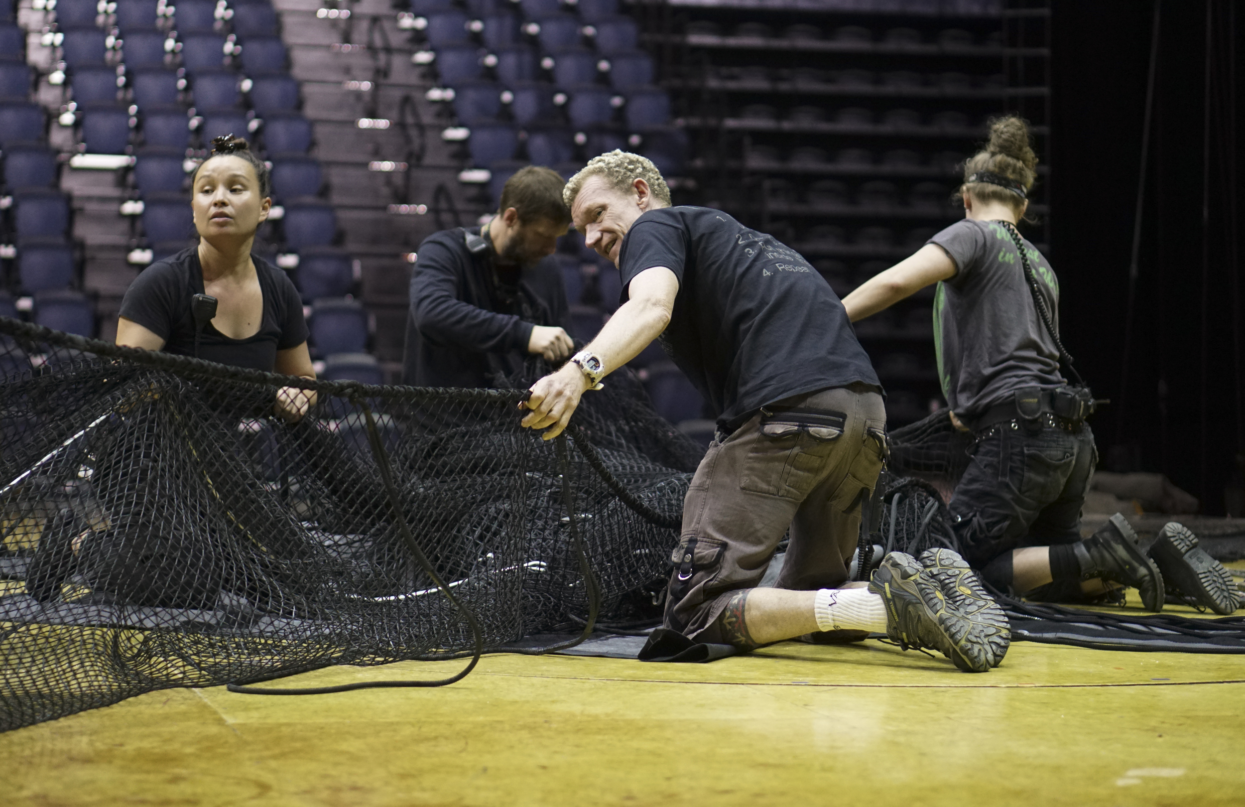 Staff Photo by Dan Henry / The Chattanooga Times Free Press- 7/20/16. Technicians remove the safety net before the opening night of the OVO Cirque Du Soleil being held at McKenzie arena in Chattanooga, Tenn., July 20-24 2016. The OVO Cirque show features performers as insects in colorful costumes performing acts including foot juggling, hand balancing, rock climbing, acrobatics and slack lining.