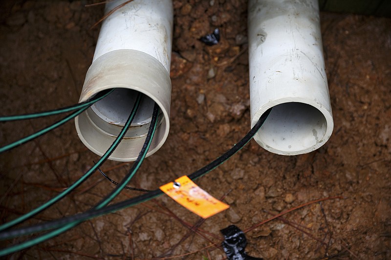 Fiber optic cables run into pipes during an EPB installation at CityGreen Apartments earlier this year.