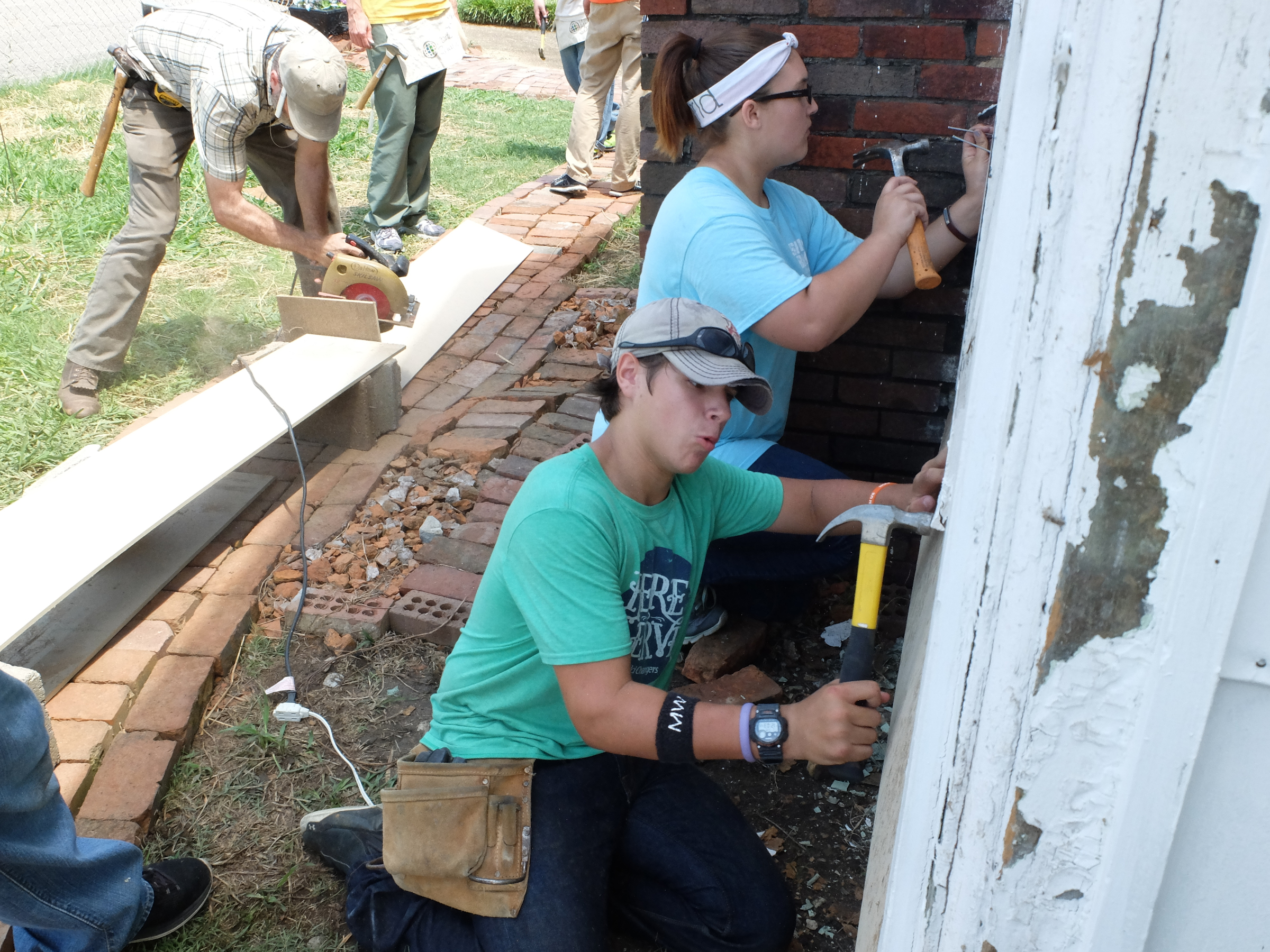 Teens Conner Selph and Mara Gibson, both of Hoboken, Ga., install siding with their World Changers crew.