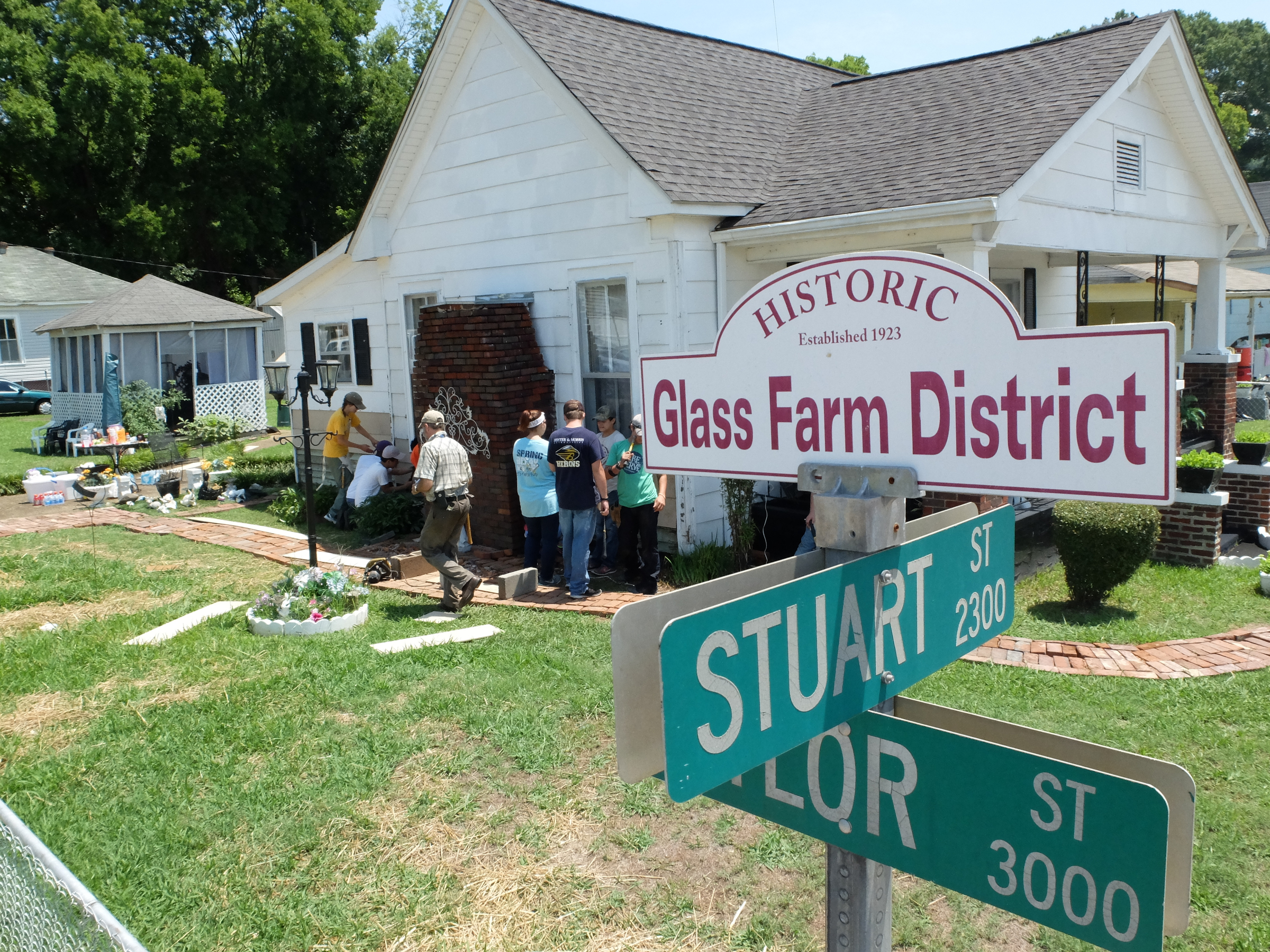 A group of teens install siding at a home on Stuart Street, one of 30 Chattanooga worksites where World Changers' volunteer mission teams are doing lawn maintenance, home repairs, painting and other projects.