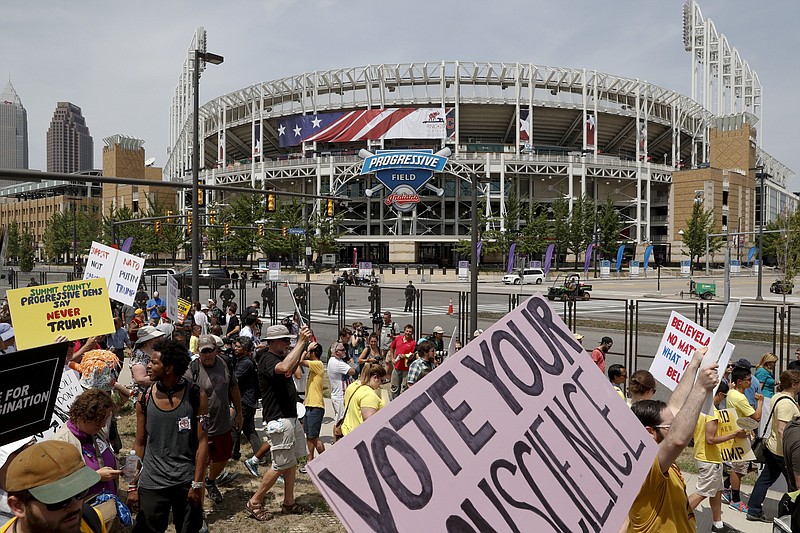 Demonstrators make their way over the Lorain-Carnegie bridge into downtown Cleveland during a protest, Thursday, during the final day of the Republican convention. (AP Photo/John Minchillo)