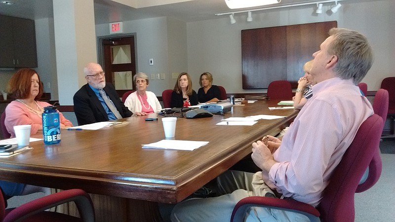 Helen Burns Sharp, far left, and Franklin McCallie, second from left, raise questions Thursday with the Chattanooga Downtown Redevelopment Corp. board about a deal to let future residents of a North Shore apartment building under construction lay claim to public parking spaces near Renaissance Park.