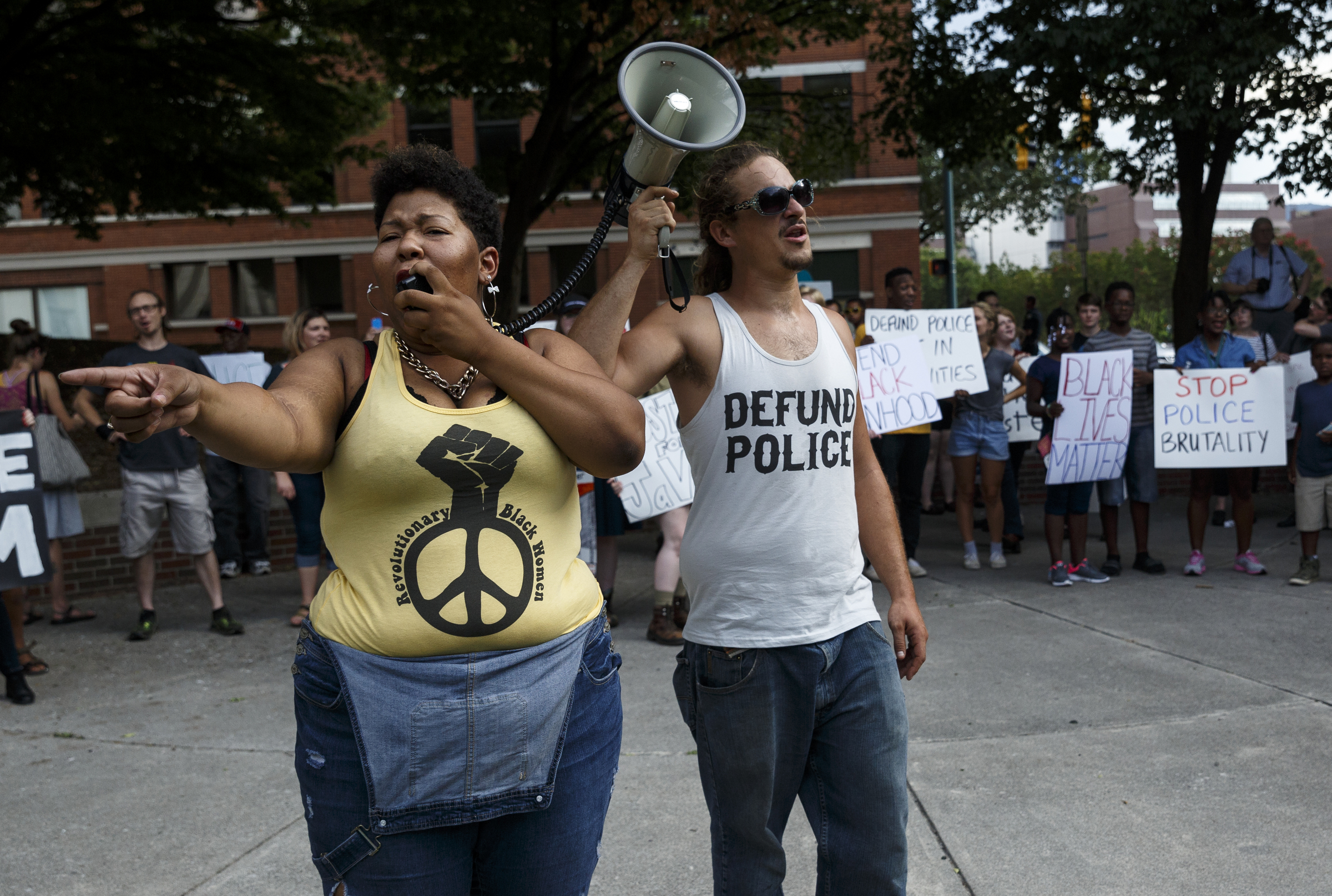 Protesters Aysja Pryor, left, and Nathan King shout during a Black Lives Matter protest in Miller Park on Thursday, July 21, 2016, in Chattanooga, Tenn. Protesters marched from Miller Park to the Tennessee Aquarium and back, stopping and blocking numerous intersections along the route.