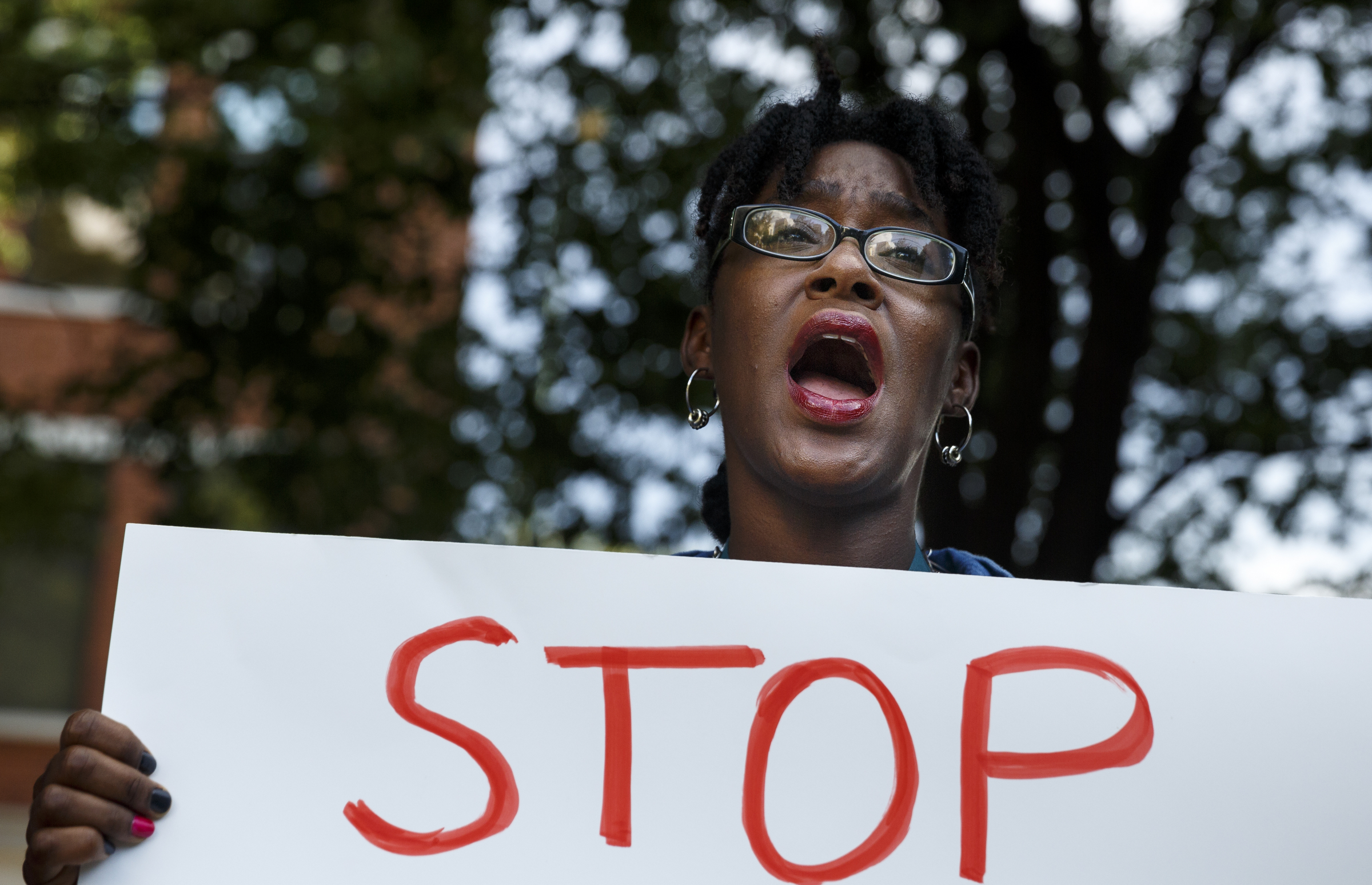 Cydni Myers chants during a Black Lives Matter protest in Miller Park on Thursday, July 21, 2016, in Chattanooga, Tenn. Protesters marched from Miller Park to the Tennessee Aquarium and back, stopping and blocking numerous intersections along the route.