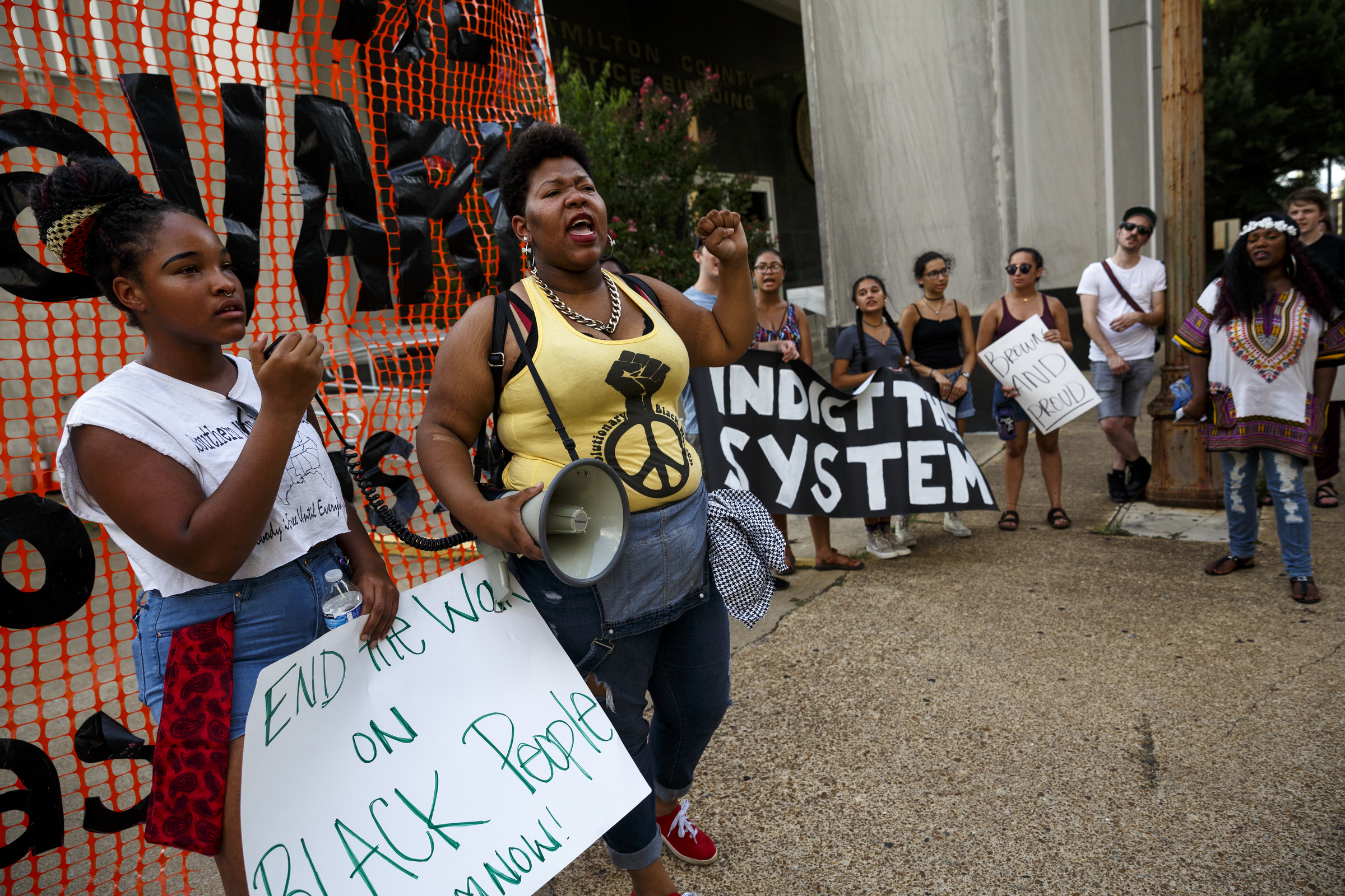 Protesters Aysja Pryor, center, and Bailey Allan shout as they protest in front of the Hamilton County Jail during a Black Lives Matter protest Thursday, July 21, 2016, in Chattanooga, Tenn. Protesters marched from Miller Park to the Tennessee Aquarium and back, stopping and blocking numerous intersections along the route.