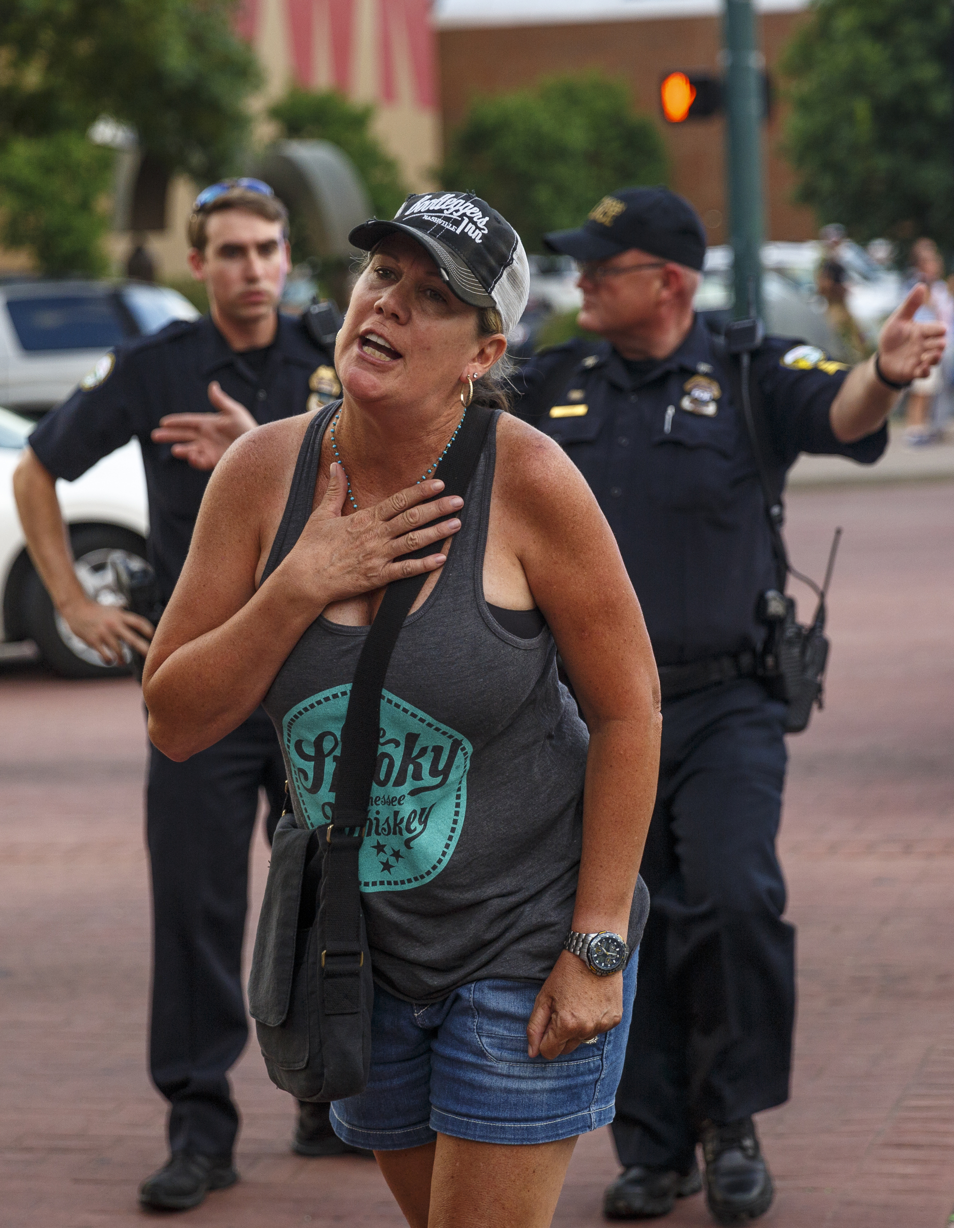Lori Unsinger yells at protesters who shut down the intersection of Broad Street and 3rd Street during a Black Lives Matter protest Thursday, July 21, 2016, in Chattanooga, Tenn. Protesters marched from Miller Park to the Tennessee Aquarium and back, stopping and blocking numerous intersections along the route.