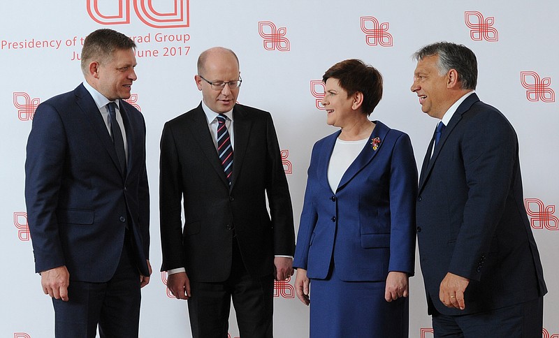 
              Prime Ministers of the Visegrad Group countries, Slovakia's Robert Fico, left, , Czech Republic's Bohuslav Sobotka, second left, Poland's Beata Szydlo and Hungary's Victor Orban, right, pose for a photo prior to their meeting in Warsaw, Poland, Thursday, July 21, 2016. Poland's prime minister is hosting her counterparts from the Visegrad Group of central European countries for talks on the European Union's future in the wake of Britain's decision to leave the EU. (AP Photo/Alik Keplicz)
            