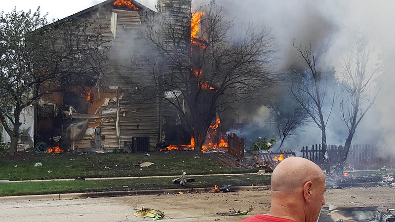 
              CORRECTS CITY TO PLAINFIELD, NOT JOLIET - A home burns following a plane crash in Plainfield, Ill., Thursday, July 21, 2016. (Suzanne Baker/Chicago Tribune via AP)
            