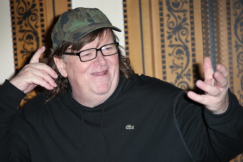 
              FILE - In this June 9, 2016, file photo, director Michael Moore reacts as he poses for photographers at the photo call of his new film, 'Where To Invade Next' in London. Moore said during an online edition of HBO's "Real Time with Bill Maher" in July 20, 2016, that he thinks Republican Donald Trump is going to win the upcoming presidential election. (Photo by Joel Ryan/Invision/AP, File)
            