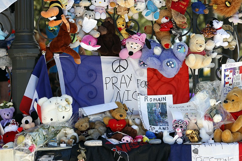 Dolls and teddy bears are placed at a memorial in a gazebo on the Promenade des Anglais in Nice, southern France, Wednesday, July 20, 2016. Joggers, cyclists and sun-seekers are back on Nice's famed Riviera coast, a further sign of normal life returning on the Promenade des Anglais where dozens were killed in last week's Bastille Day truck attack.