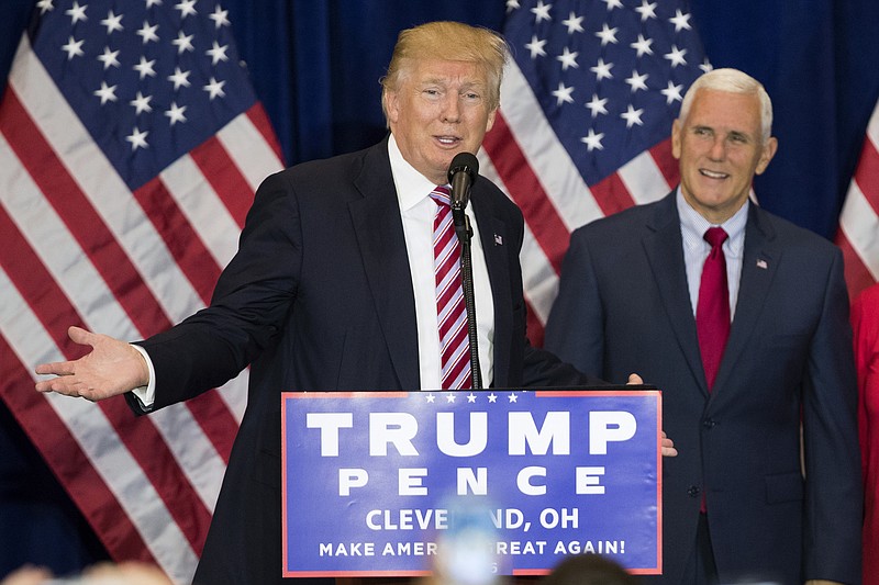 
              Vice presidential running mate Gov. Mike Pence, R-Ind., right, listens as Republican presidential candidate Donald Trump speaks during an goodbye reception with friends and family following the Republican National Convention, Friday, July 22, 2016, in Cleveland. (AP Photo/Evan Vucci)
            