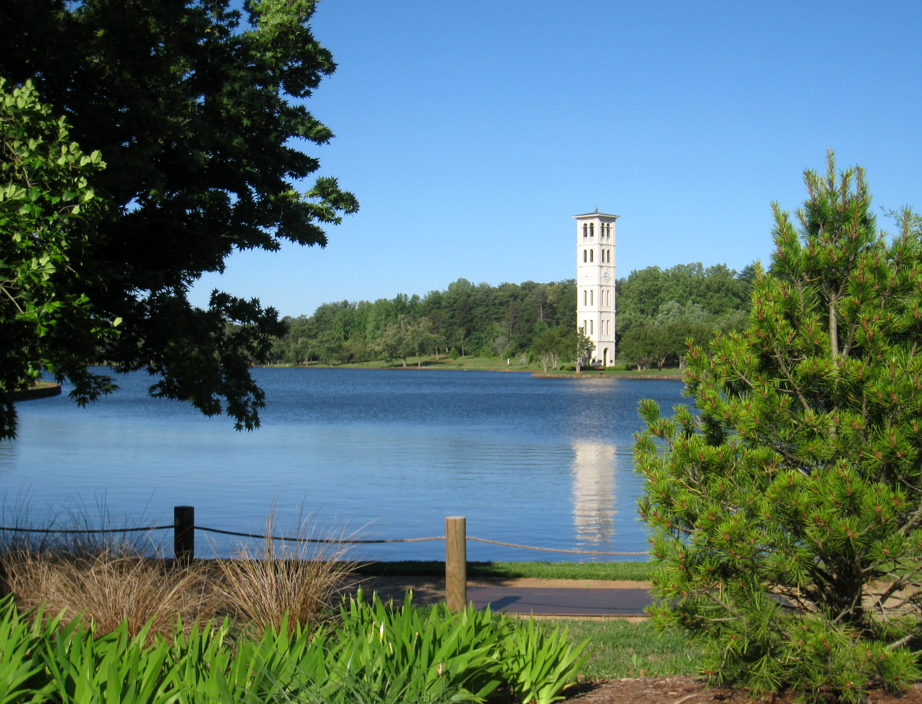 A view of Furman University's iconic bell tower can be seen across the lake.