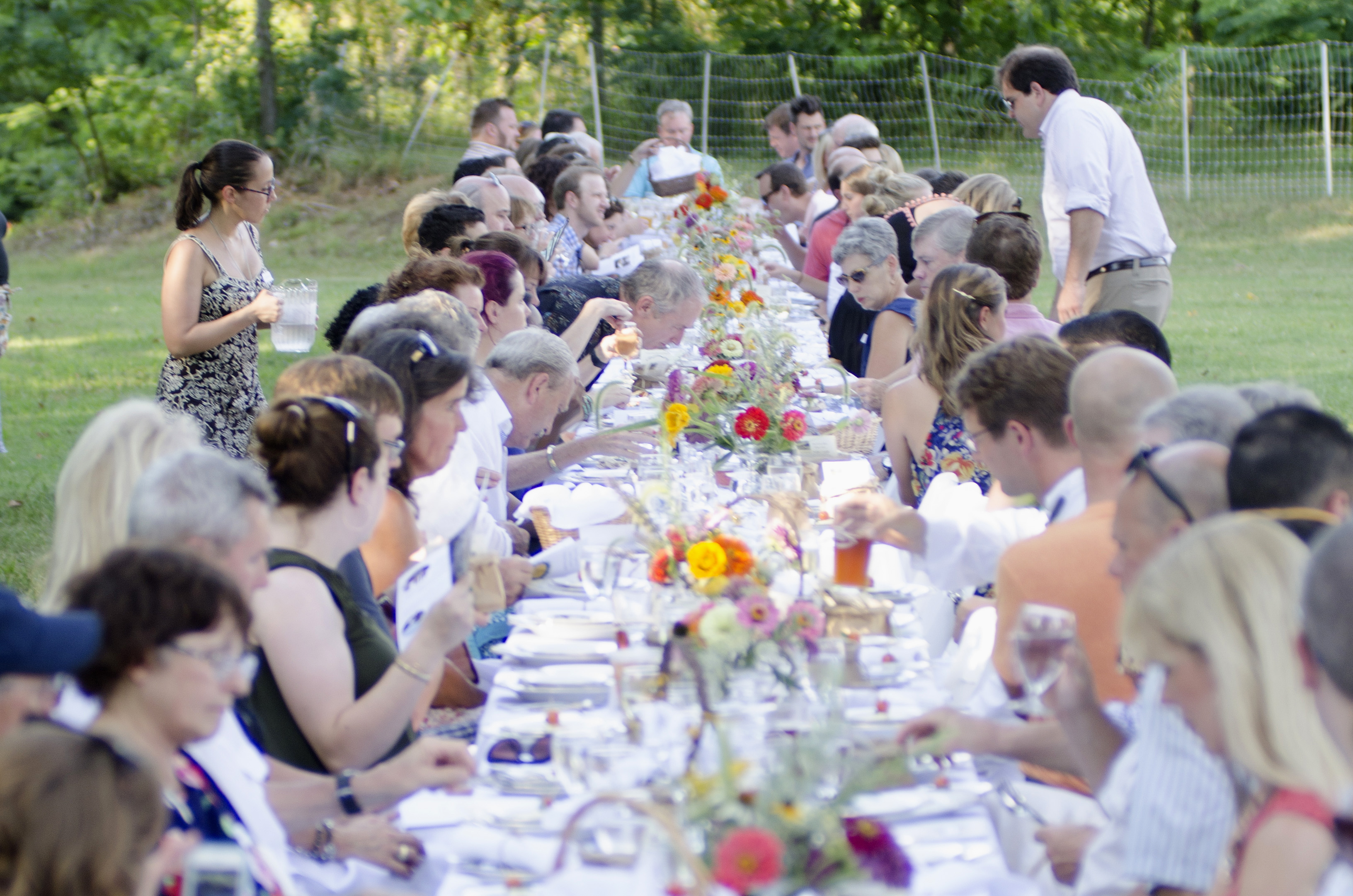 Guests begin to take their seats for the 100 Dinner at Crabtree farms.