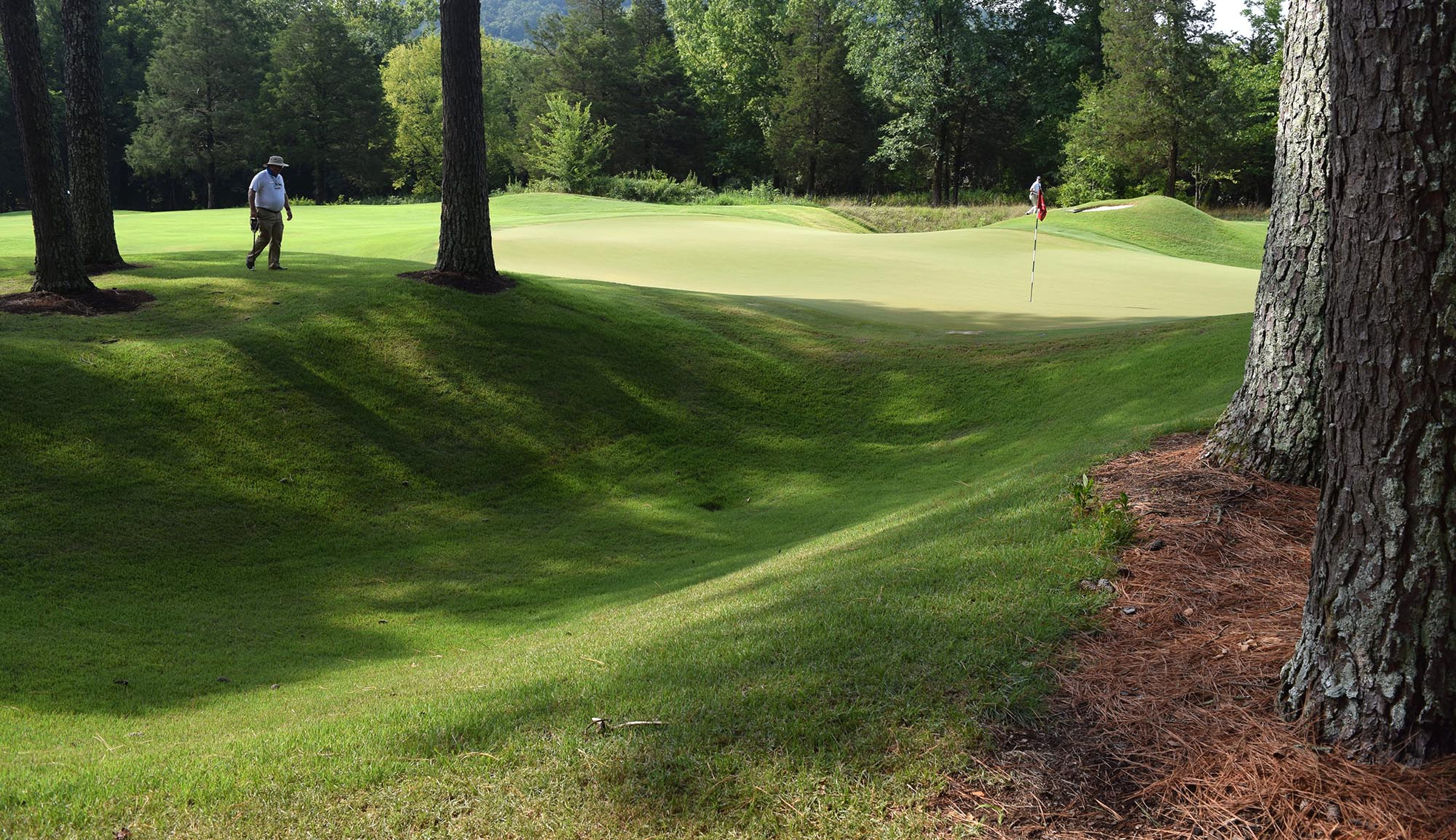 A USGA official walks through the shadows on the 13th hole.  The fifth day of the 69th U.S. Junior Amateur Championship was held at the Honors Course in Ooltewah, Tennessee, Friday July 22, 2016.