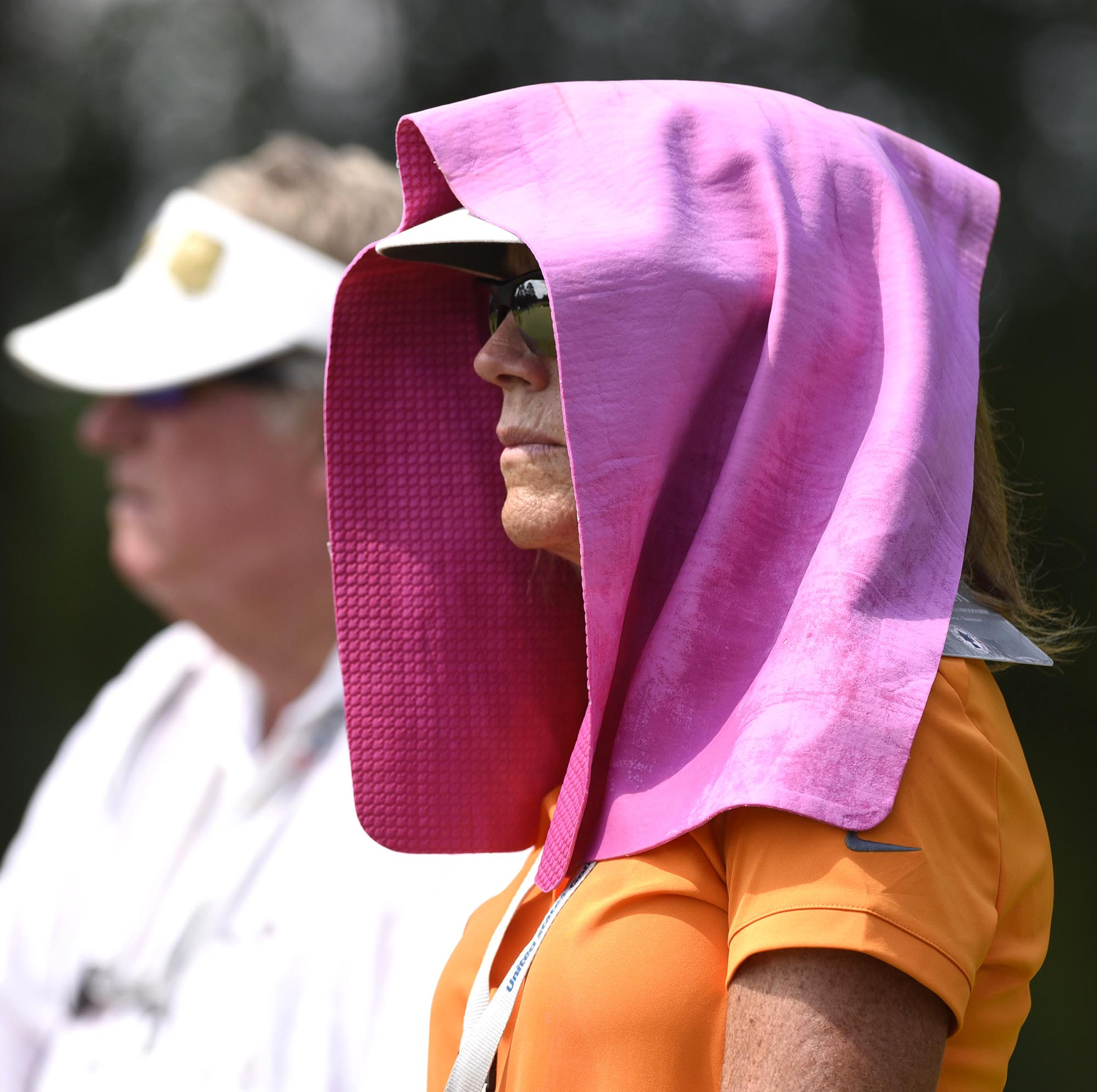 Patty Donahoo, of Chattanooga, uses a towel as cover to try beat the heat.  The fifth day of the 69th U.S. Junior Amateur Championship was held at the Honors Course in Ooltewah, Tennessee, Friday July 22, 2016.