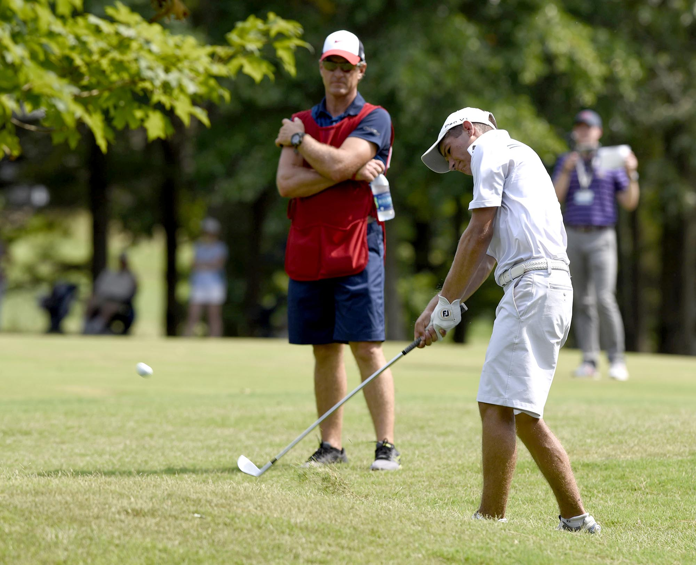 Noah Goodwin of Corinth, Texas hits a shot under the trees on the 17th hole.  Goodwin won his semifinal match over John Pak of Scotch Plains, New Jersey after 20 holes. The fifth day of the 69th U.S. Junior Amateur Championship was held at the Honors Course in Ooltewah, Tennessee, Friday July 22, 2016.