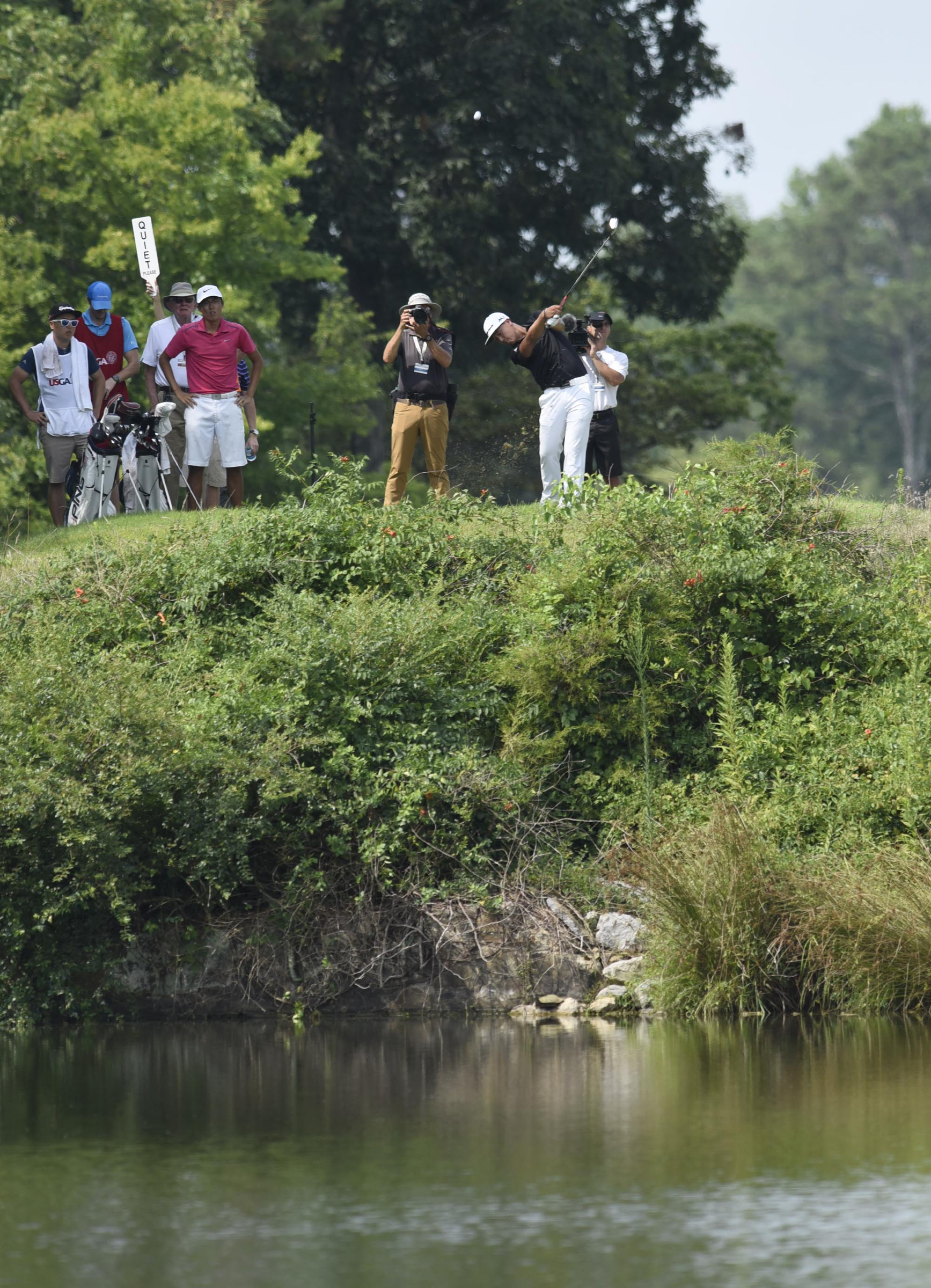 John Pak of Scotch Pines, New Jersey ties off over the water on the 16th hole.  Pak won his quarterfinal match over Won Jun Lee of the Republic of Korea 1 up.  The fifth day of the 69th U.S. Junior Amateur Championship was held at the Honors Course in Ooltewah, Tennessee, Friday July 22, 2016.