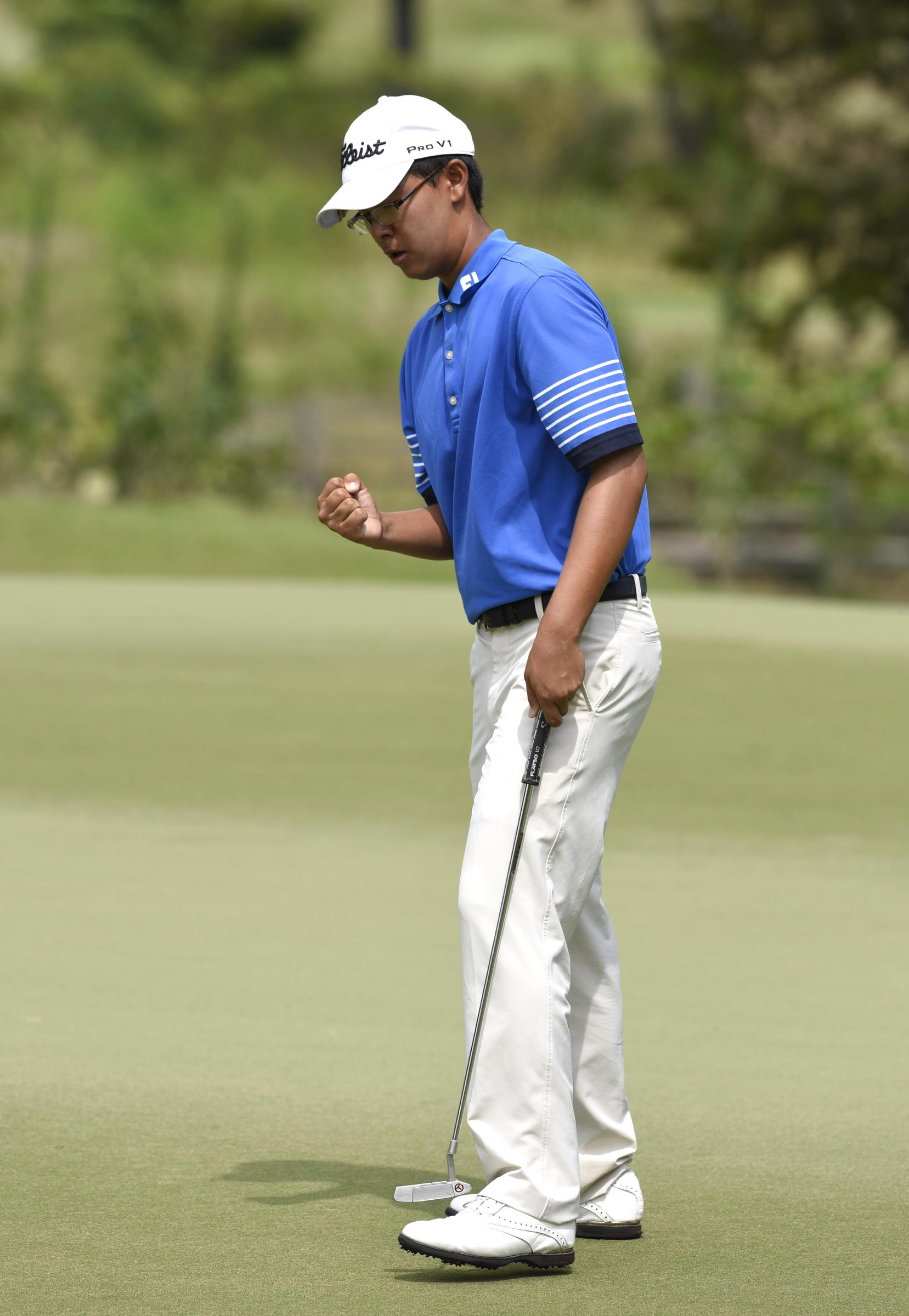 Eugene Hong of Sanford, Florida pumps his fist and he wins his match, 1 up, with Wei Wei Gao of the Philippines.  The fifth day of the 69th U.S. Junior Amateur Championship was held at the Honors Course in Ooltewah, Tennessee, Friday July 22, 2016.