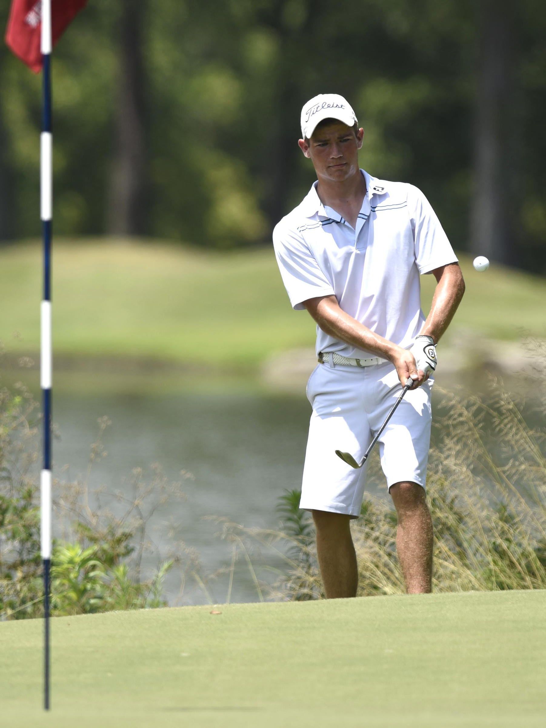 Noah Goodwin of Corinth, Texas chips from behind the 9th green.  Goodwin won his semifinal match over John Pak of Scotch Plains, New Jersey after 20 holes. The fifth day of the 69th U.S. Junior Amateur Championship was held at the Honors Course in Ooltewah, Tennessee, Friday July 22, 2016.