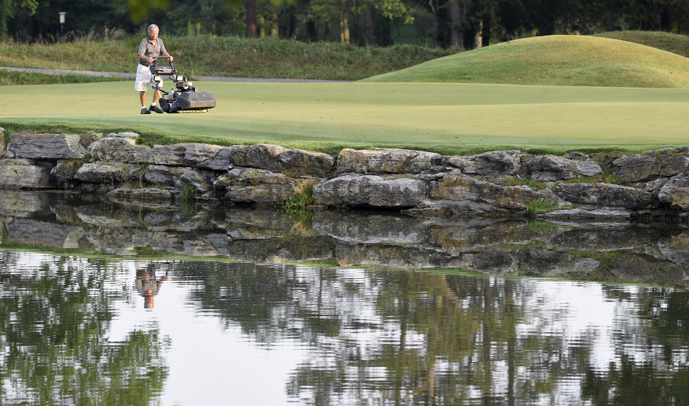 A Honors Course employee mows the 16th green before the start of play.  The fifth day of the 69th U.S. Junior Amateur Championship was held at the Honors Course in Ooltewah, Tennessee, Friday July 22, 2016.