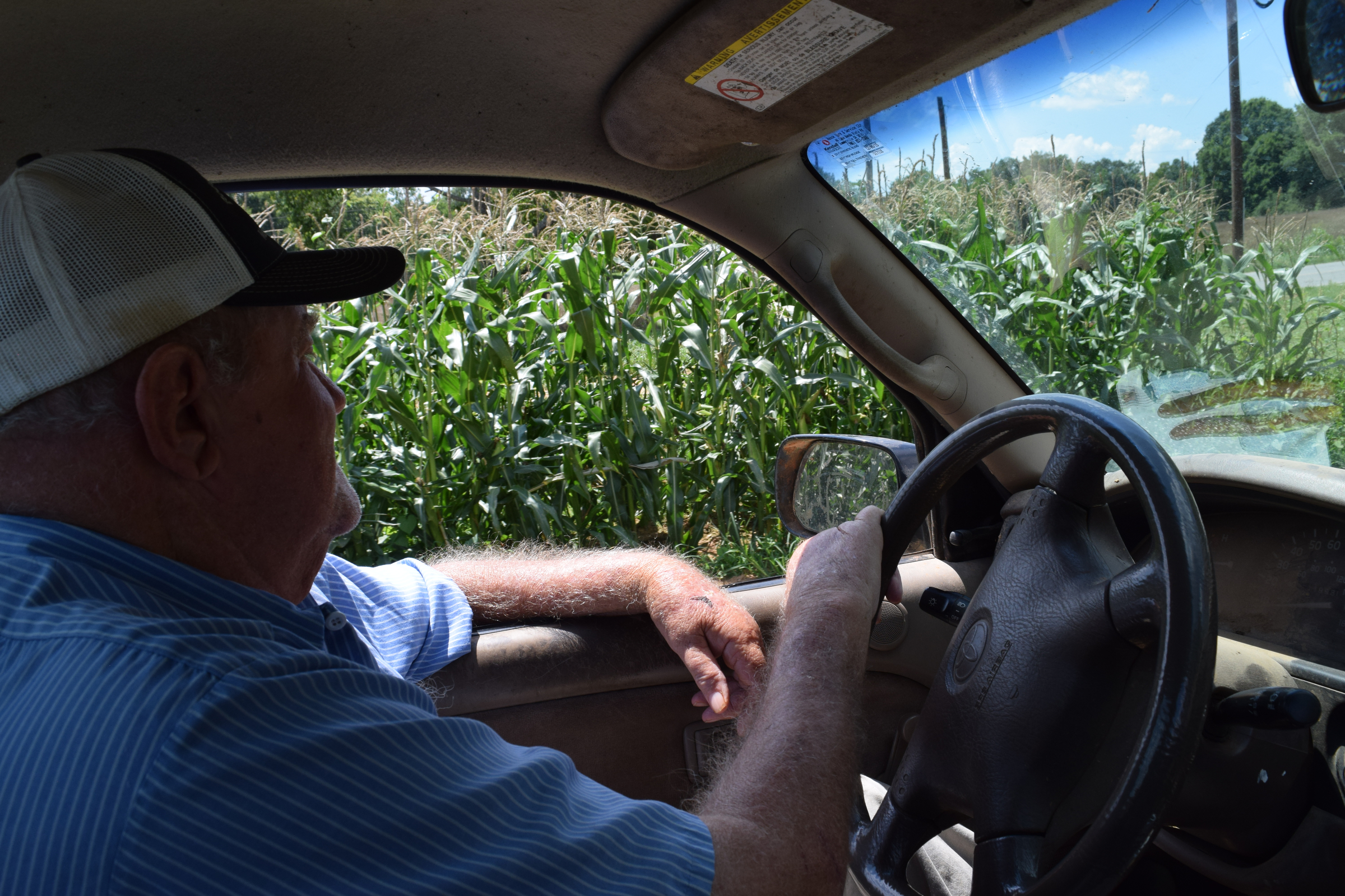 Walker County, Ga., farmer Donald Martin drives past his home garden where it took 10,000 gallons of water to get his four rows of corn to produce this summer.