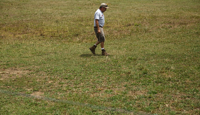 James Burton walks through a dry field on his farm on Thursday, July 21, 2016, in LaFayette, Ga. Burton says that the ongoing drought has forced him to graze cattle in fields he would normally save for next year, and while he would normally be selling his hay to customers, he has only just enough to last his own farm through the winter.