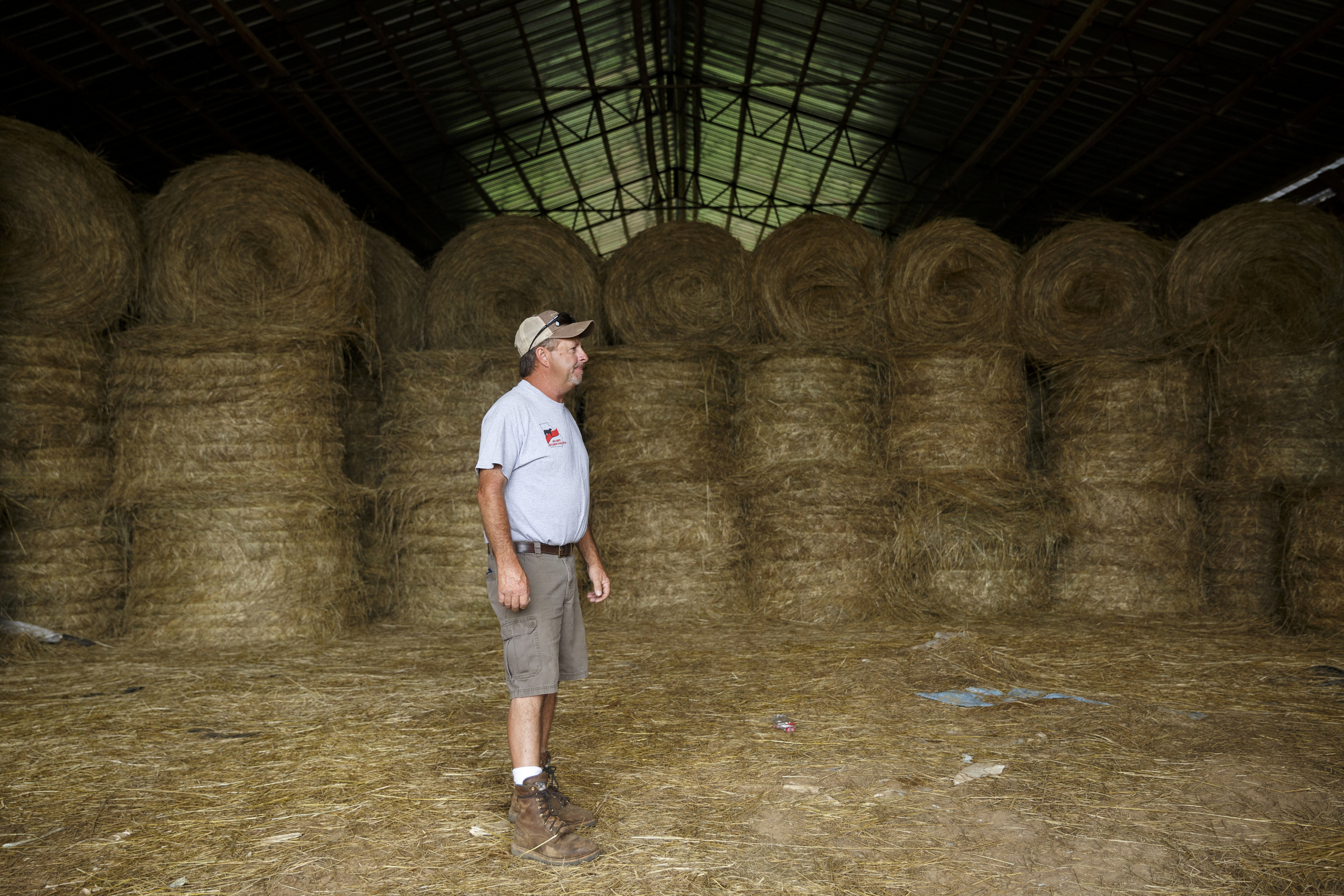 James Burton stands inside a barn that would normally be filled completely with hay from his farm, but now has only enough to last him through the winter, on Thursday, July 21, 2016, in LaFayette, Ga. Burton says that the ongoing drought has forced him to graze cattle in fields he would normally save for next year, and he has stopped selling hay to customers to keep his cattle for the winter.