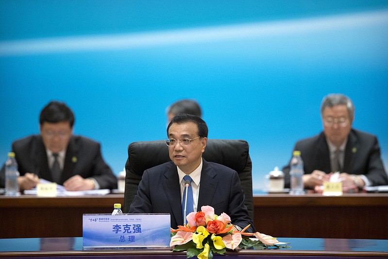 
              China's Premier Li Keqiang, center, speaks during the 1+6 Roundtable on promoting growth in the Chinese and global economies at the Diaoyutai State Guesthouse in Beijing, Friday, July 22, 2016. (AP Photo/Mark Schiefelbein)
            