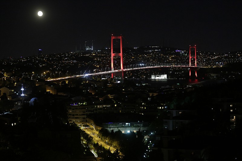 
              The moon rises behind Bosporus Bridge as pro-goverment supporters gather on the bridge to protest, late Thursday, July 21, 2016. Turkish lawmakers approved a three-month state of emergency, endorsing new powers for Turkey's President Recep Tayyip Erdogan that would allow him to expand a crackdown that has already included mass arrests and the closure of hundreds of schools, in the wake of the July 15 failed coup. (AP Photo/Petros Giannakouris)
            